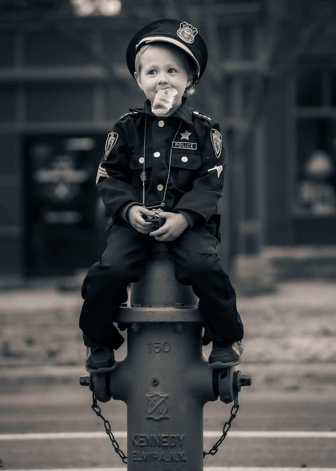 Child sitting on fire hydrant
