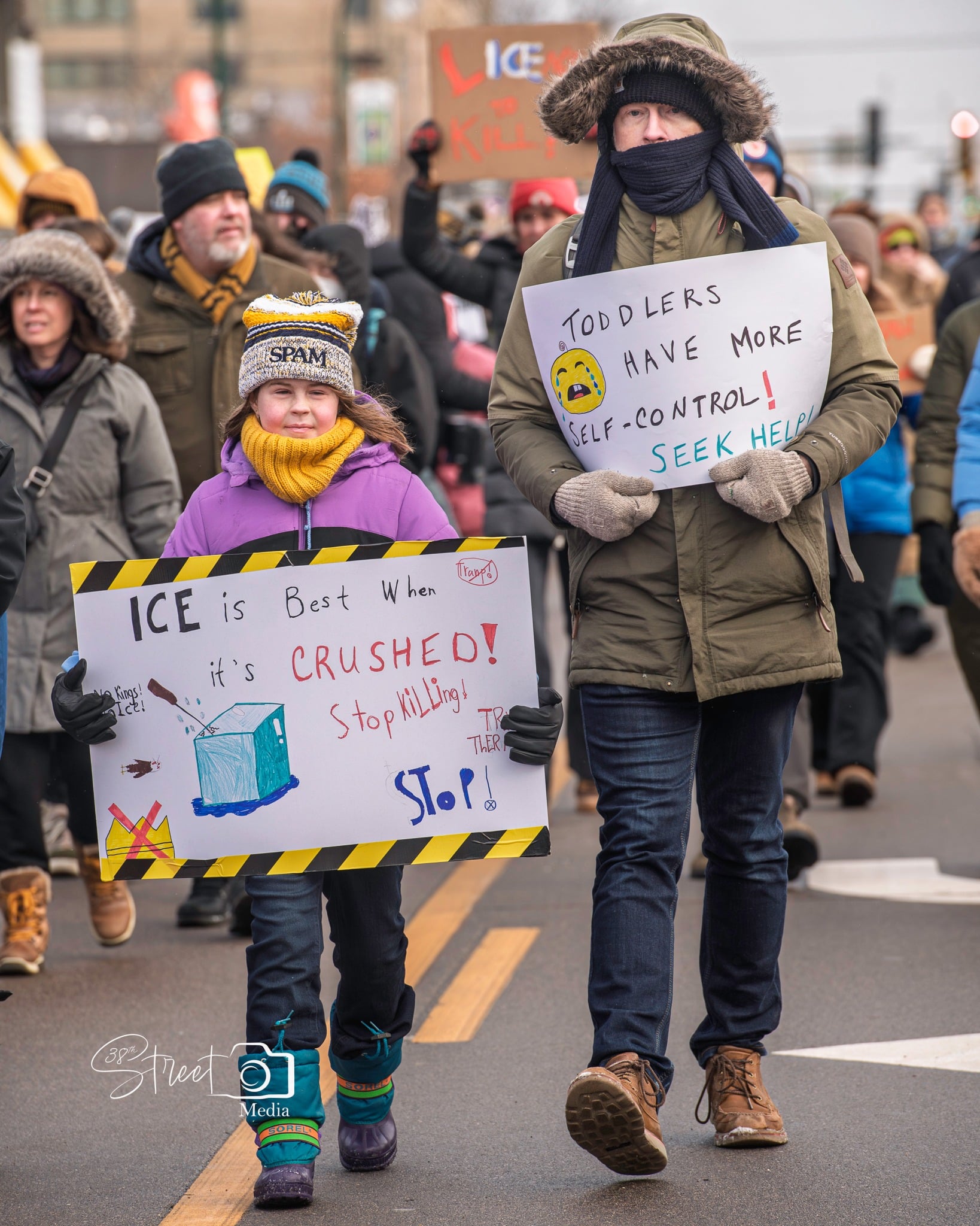 child marching during protest with sign