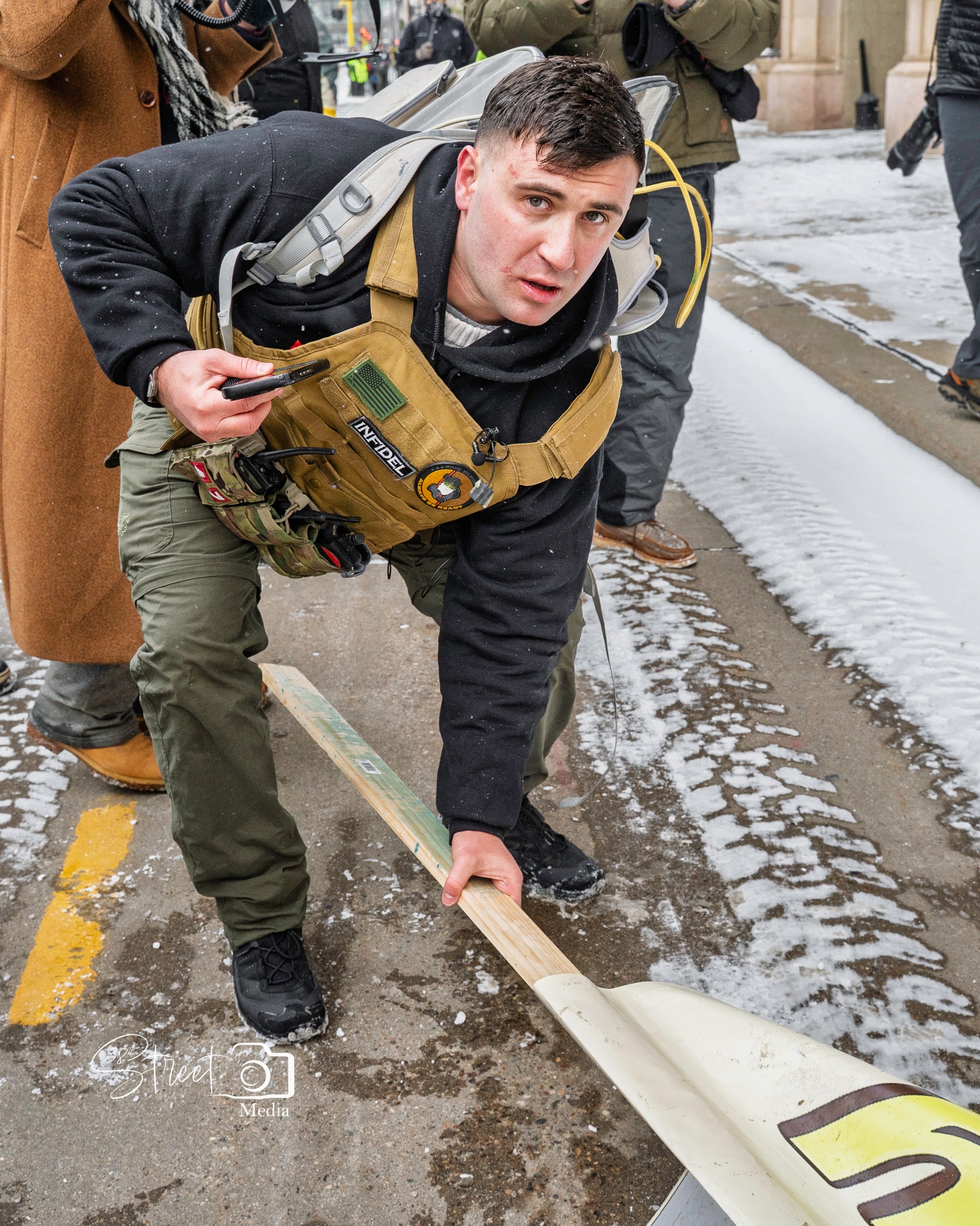 jake lang picking up fallen sign