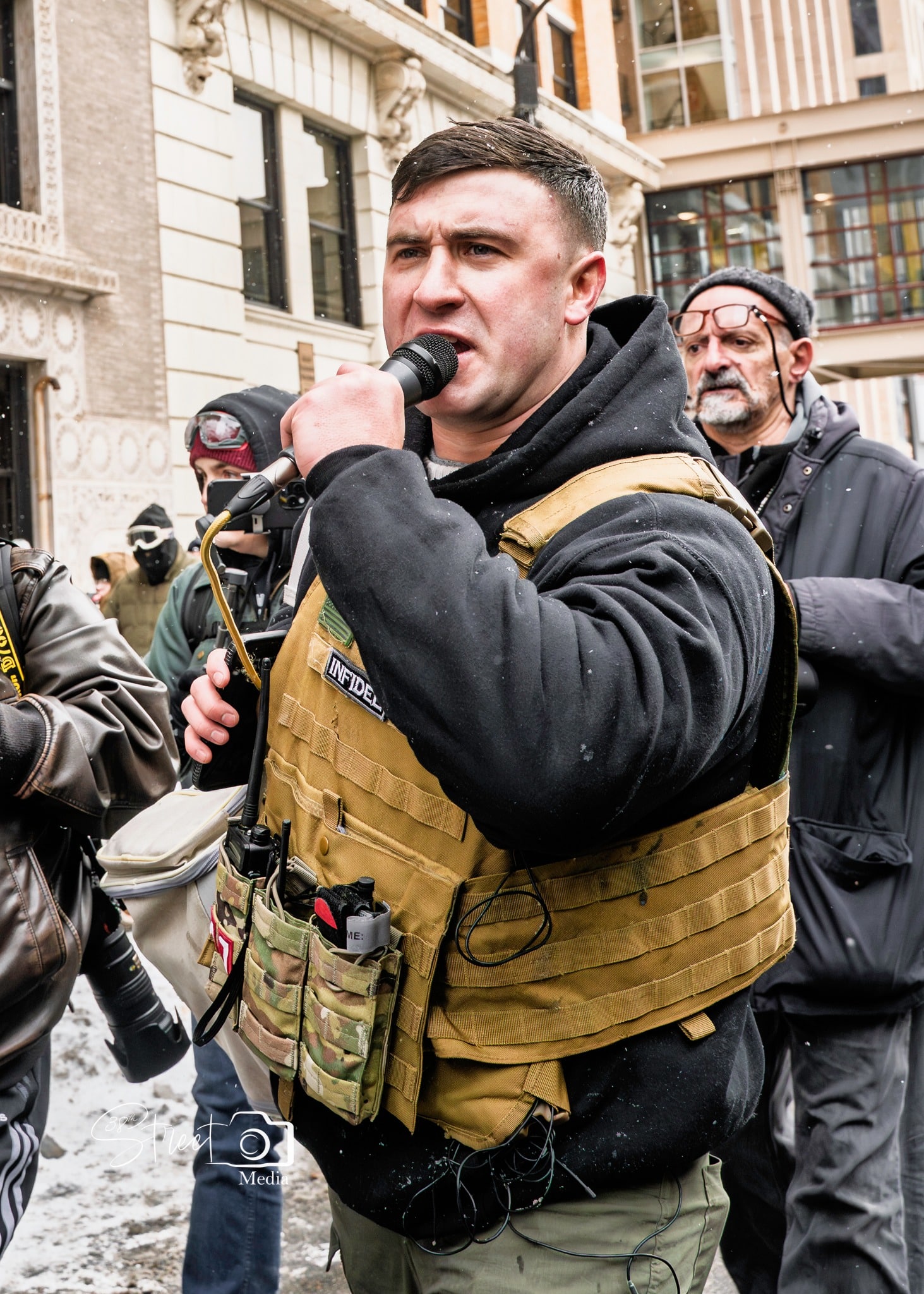 jake lang speaking at protest